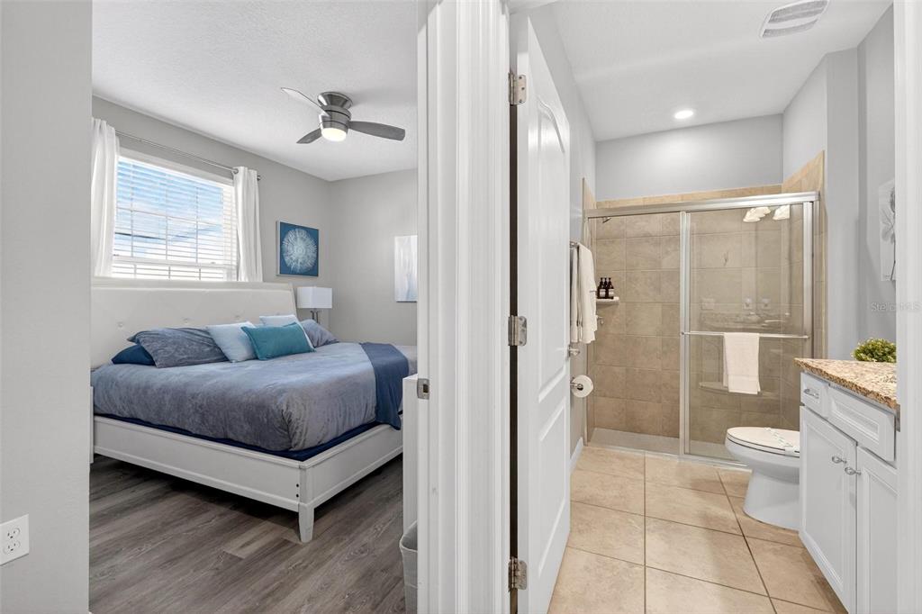 7554 Oak Spring Lane Davenport, FL 33837 - Photo 24 of 74 a living room with furniture and a glass door shower