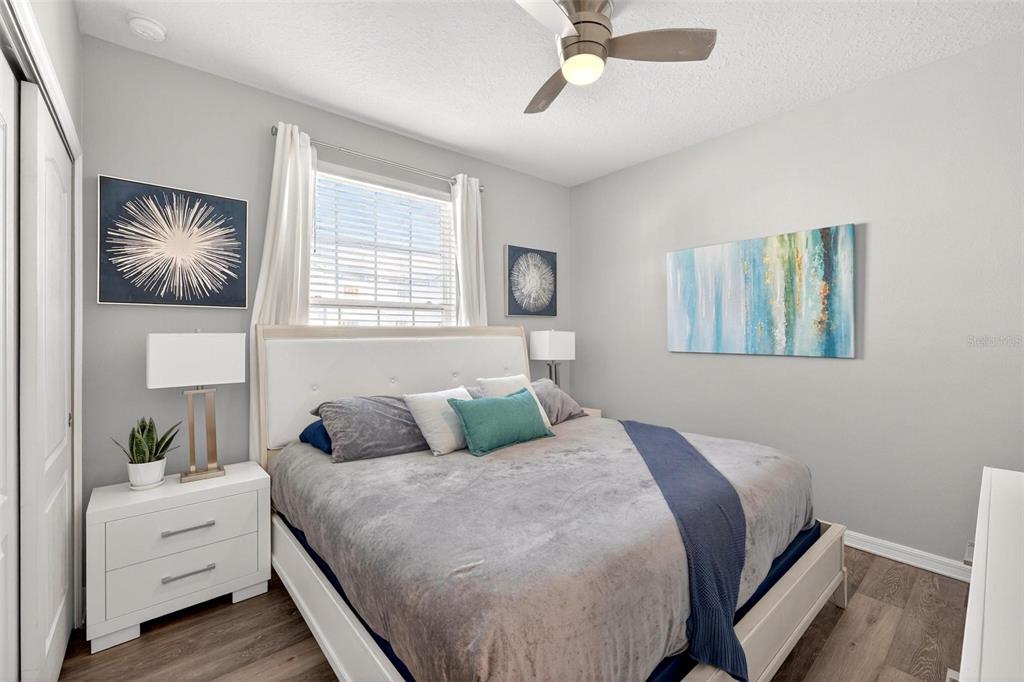 7554 Oak Spring Lane Davenport, FL 33837 - Photo 25 of 74 a bedroom with a large bed and a chandelier