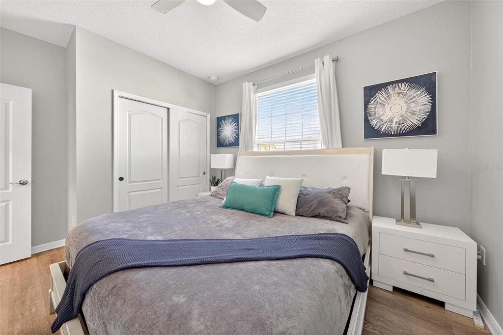 7554 Oak Spring Lane Davenport, FL 33837 - Photo 26 of 74 a bedroom with a large bed and a window
