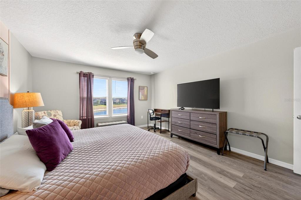7554 Oak Spring Lane Davenport, FL 33837 - Photo 35 of 74 a bedroom with a bed and flat screen tv