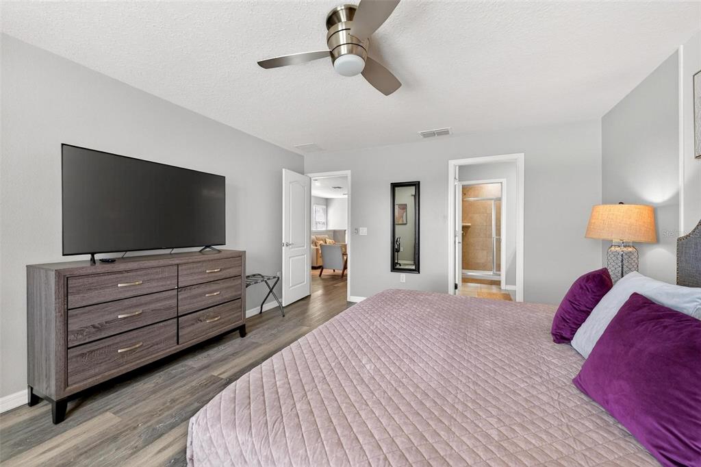 7554 Oak Spring Lane Davenport, FL 33837 - Photo 36 of 74 a bedroom with furniture and flat screen tv