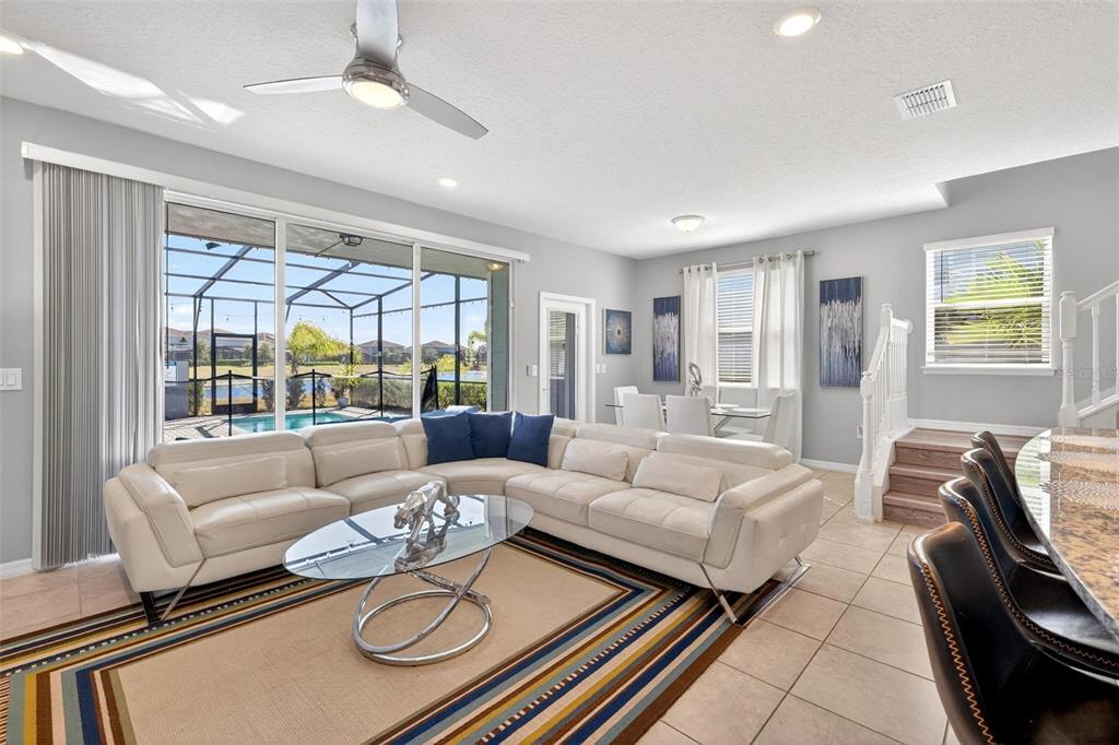 7554 Oak Spring Lane Davenport, FL 33837 - Photo 4 of 74 a living room with furniture and a large window