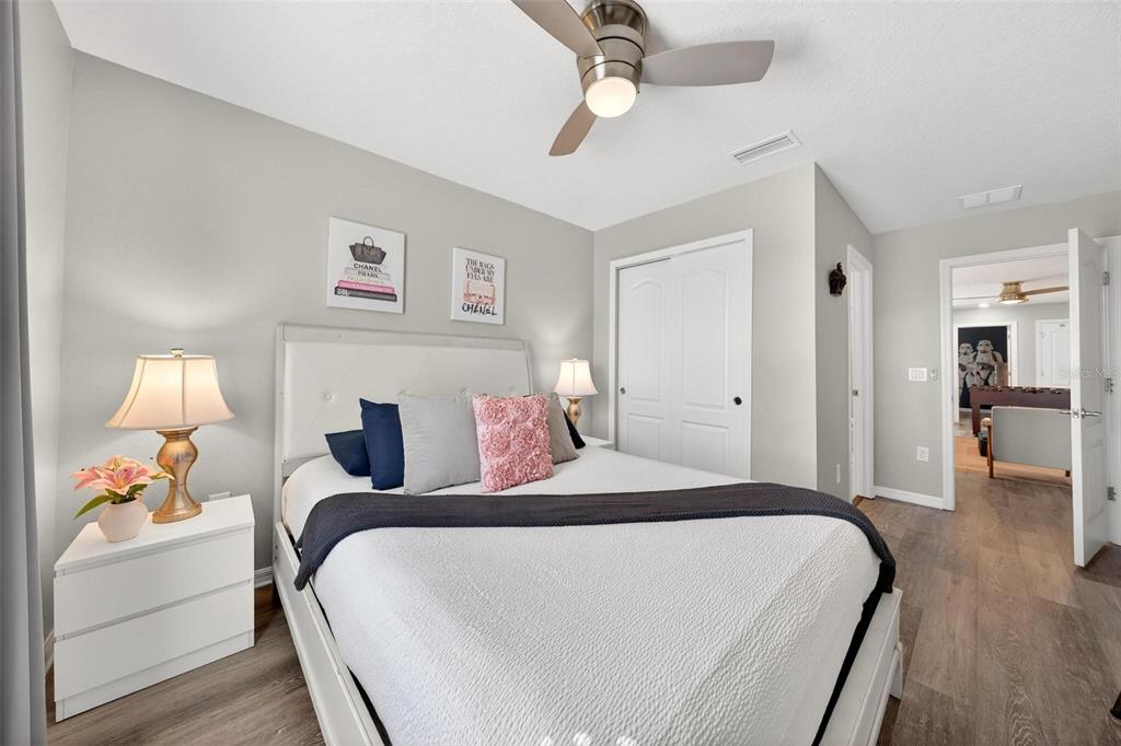 7554 Oak Spring Lane Davenport, FL 33837 - Photo 44 of 74 a bedroom with a bed and a chandelier