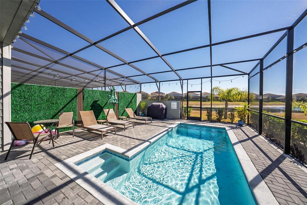 7554 Oak Spring Lane Davenport, FL 33837 - Photo 55 of 74 a view of a patio with table and chairs a barbeque with wooden floor