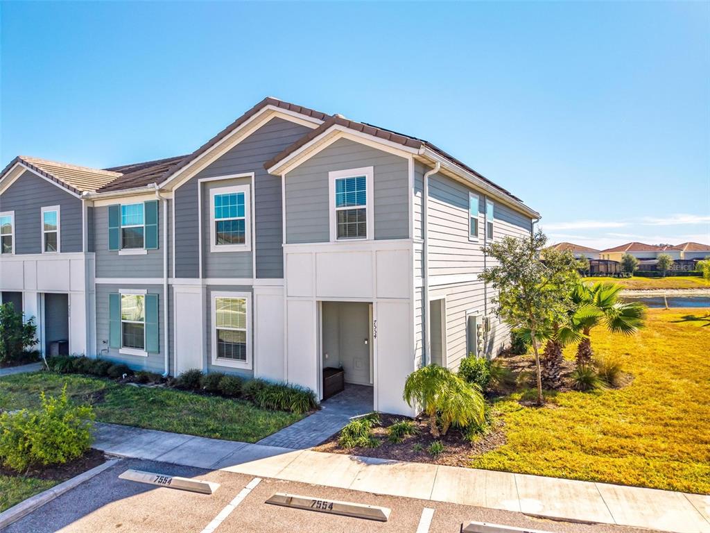 7554 Oak Spring Lane Davenport, FL 33837 - Photo 56 of 74 a front view of a house with garden