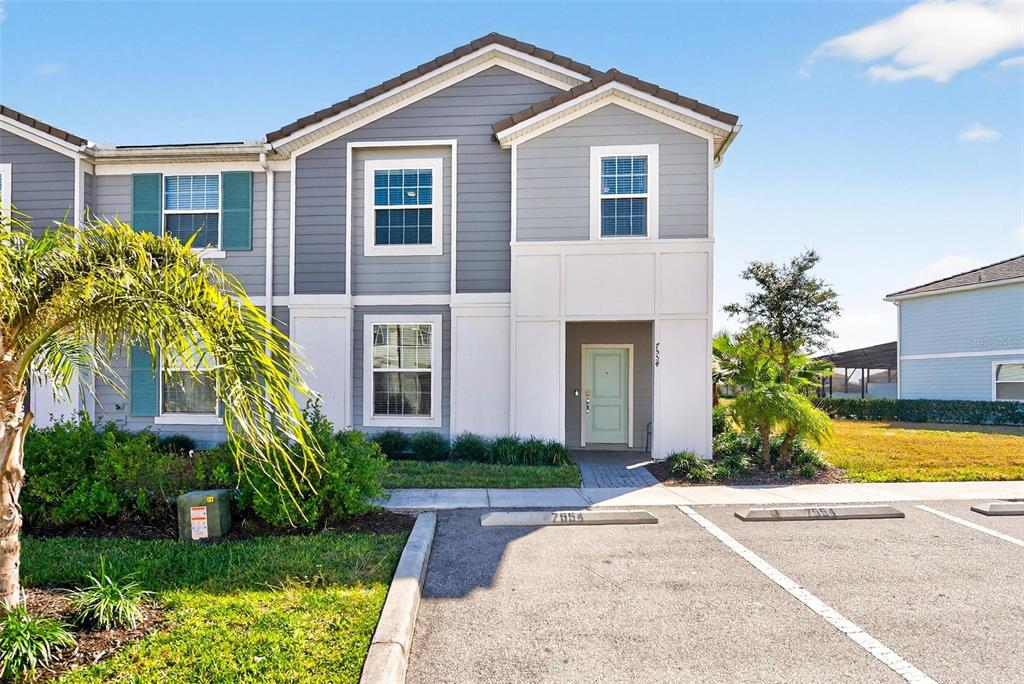 7554 Oak Spring Lane Davenport, FL 33837 - Photo 62 of 74 a front view of a house with garden