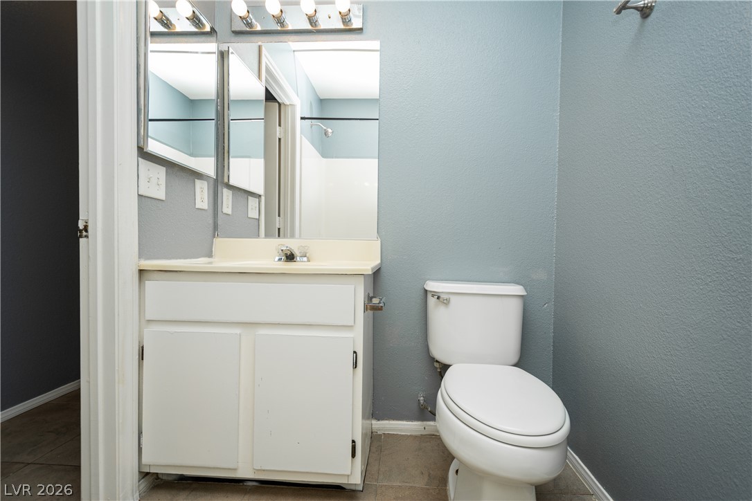 1444 Star Road Pahrump, NV 89048 - Photo 24 of 37 Functional bathroom layout features a white vanity, mirrored medicine cabinets, and tile flooring.