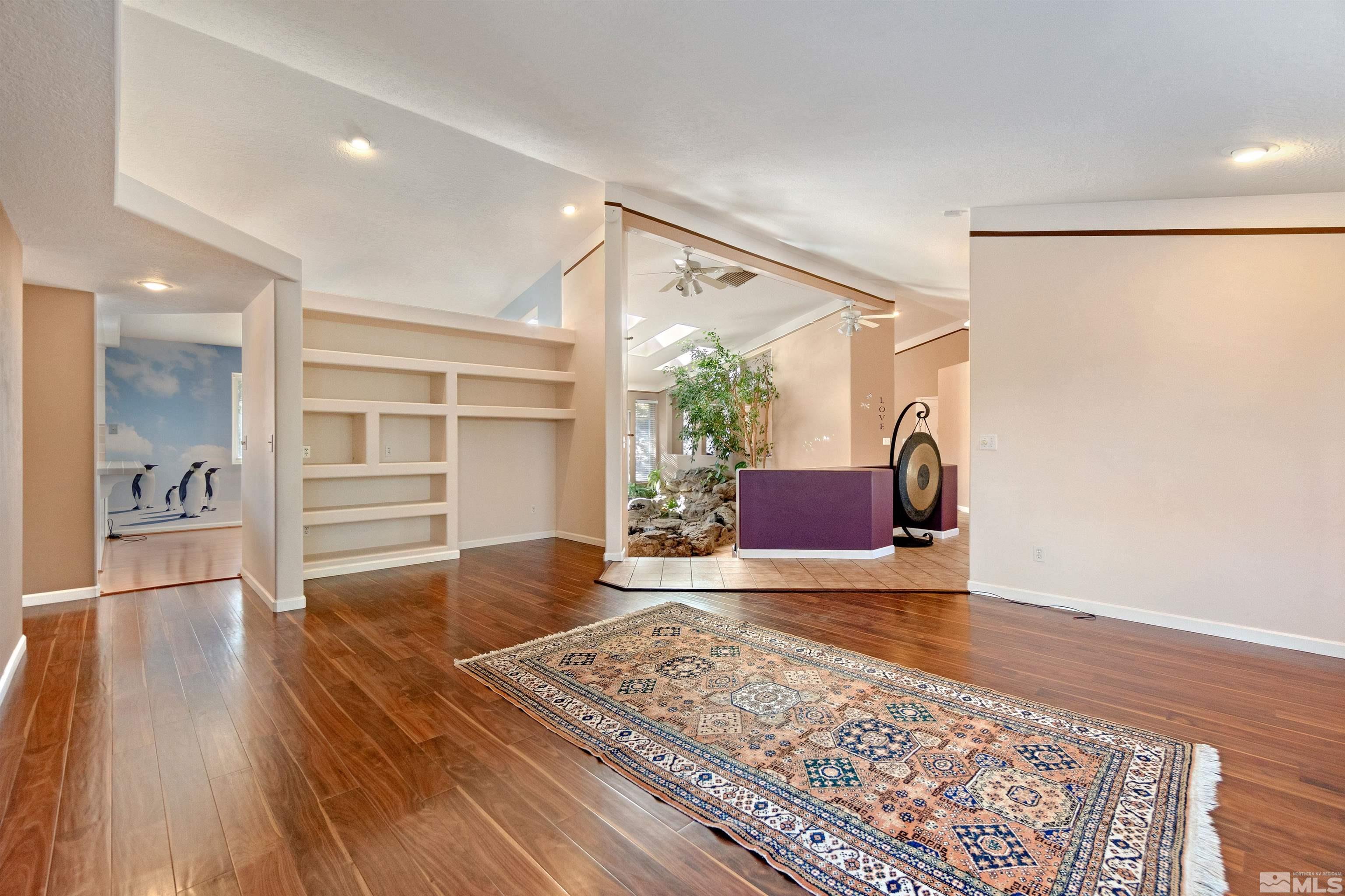 1200 Lampe Road Reno, NV 89511 - Photo 12 of 34 a living room with a couch and a rug with wooden floor