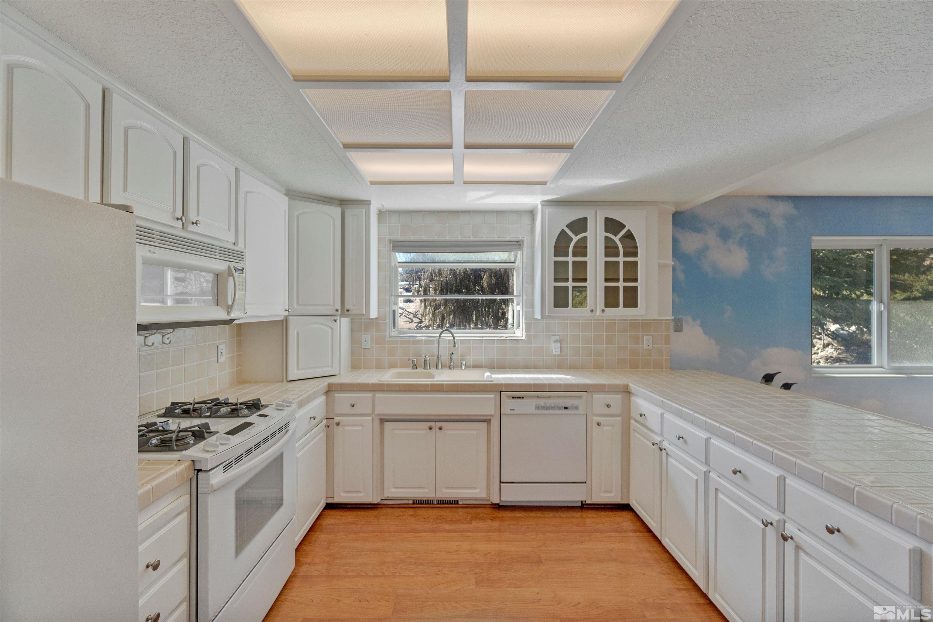 1200 Lampe Road Reno, NV 89511 - Photo 13 of 34 a kitchen with a sink stove and cabinets