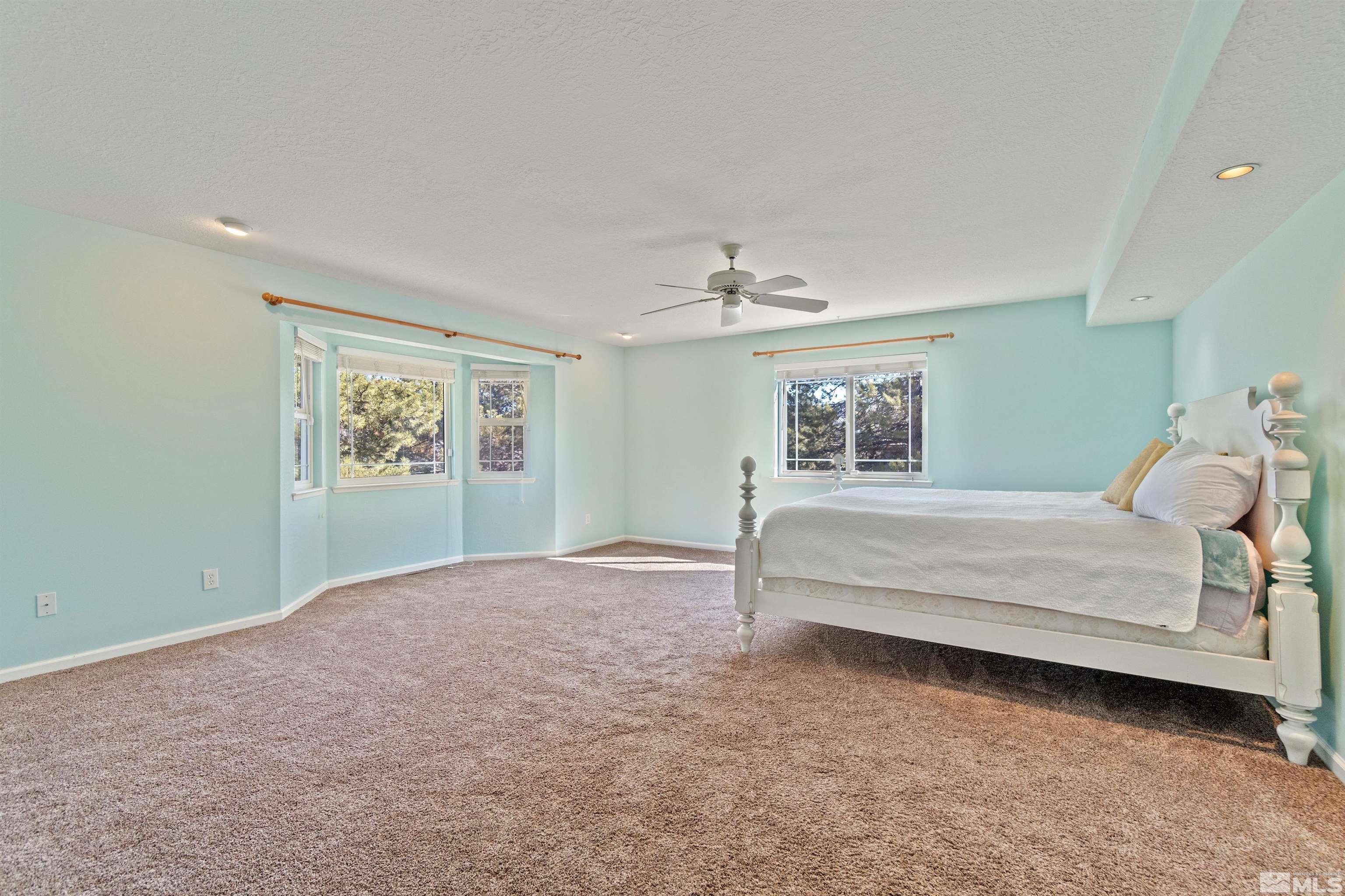 1200 Lampe Road Reno, NV 89511 - Photo 23 of 34 a bedroom with a bed and a chandelier