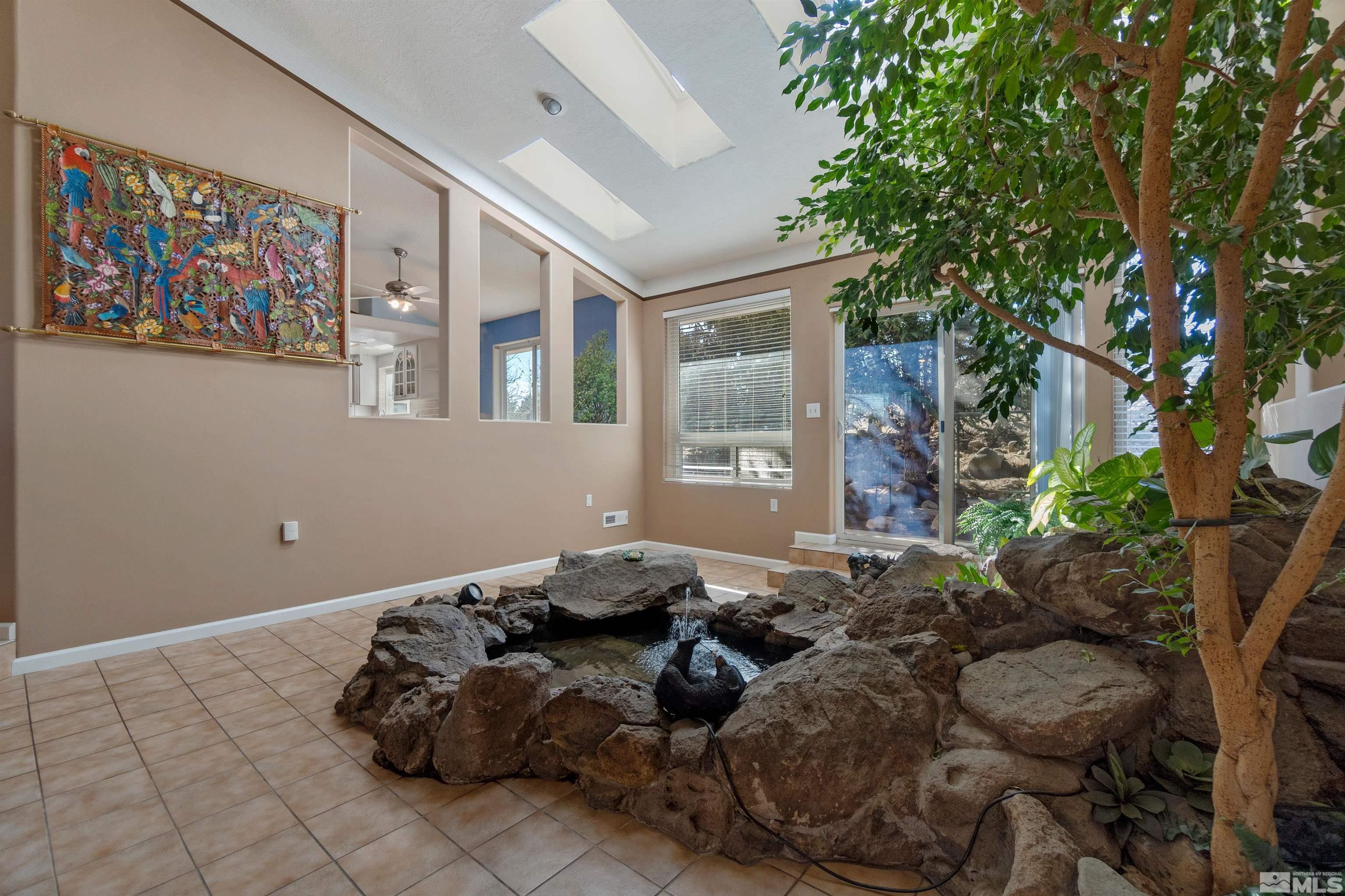 1200 Lampe Road Reno, NV 89511 - Photo 8 of 34 a bed sitting in a bedroom next to a window with potted plants