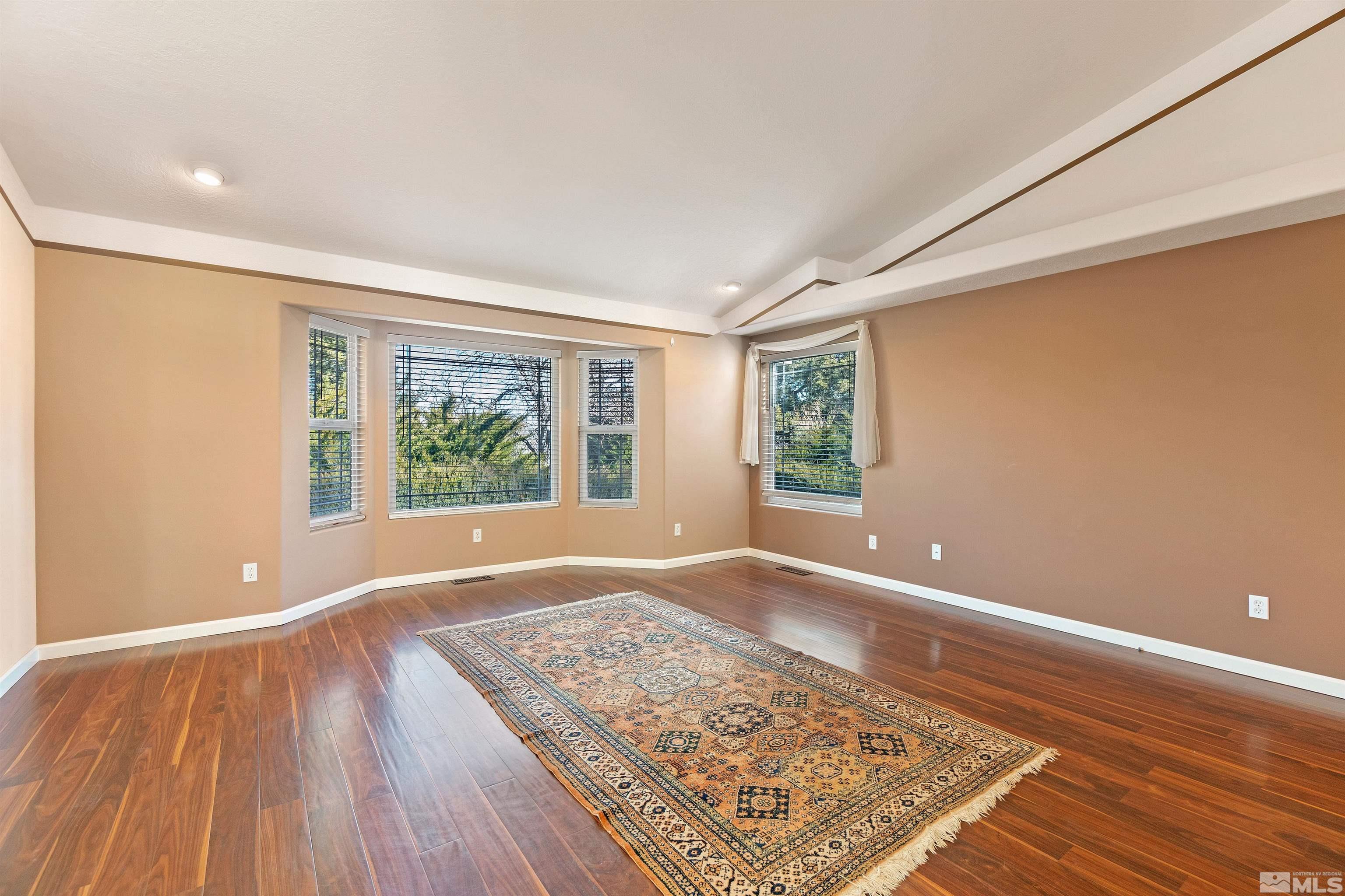 1200 Lampe Road Reno, NV 89511 - Photo 10 of 34 an empty room with wooden floor and windows