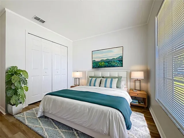 a bedroom with a large bed and a window