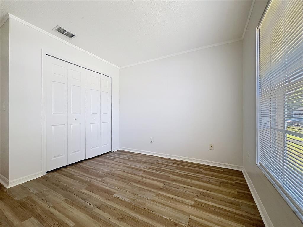 137 Piano Lane Davenport, FL 33896 - Photo 12 of 13 wooden floor in an empty room