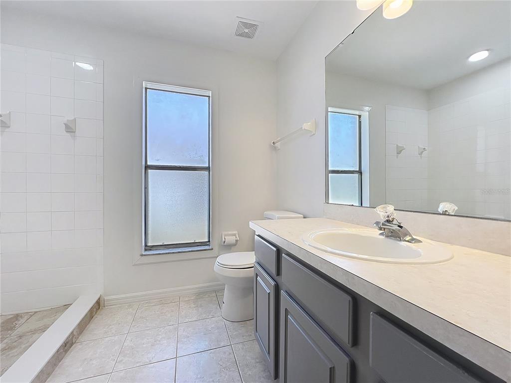 137 Piano Lane Davenport, FL 33896 - Photo 13 of 13 a bathroom with a sink toilet and mirror