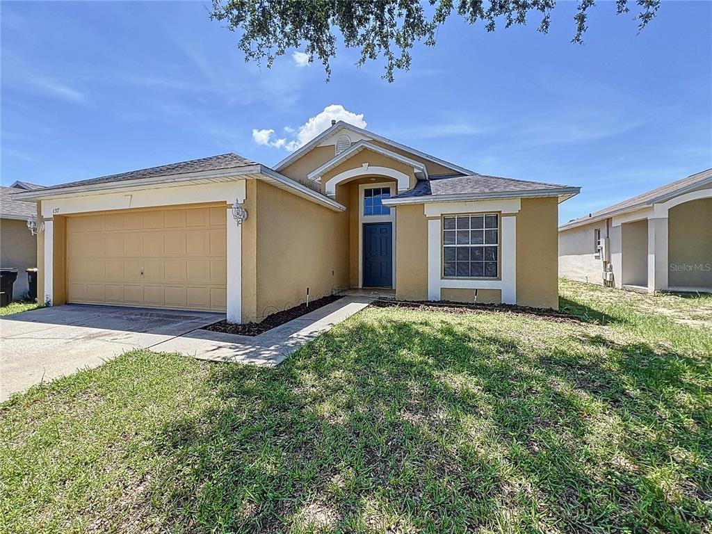 137 Piano Lane Davenport, FL 33896 - Photo 2 of 13 a front view of house with yard