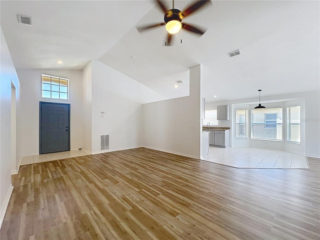 137 Piano Lane Davenport, FL 33896 - Photo 4 of 13 a view of empty room with wooden floor and fan