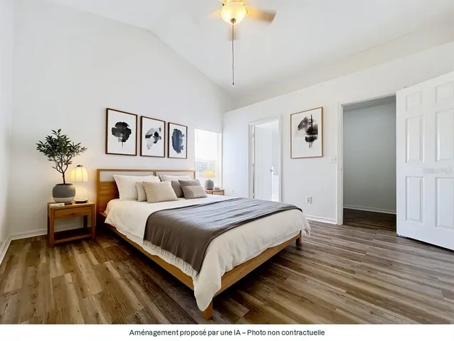 a bedroom with a bed and a potted plant