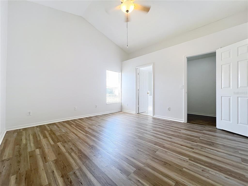 137 Piano Lane Davenport, FL 33896 - Photo 9 of 13 a view of empty room with wooden floor and fan