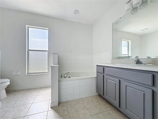 a bathroom with a sink a toilet and tub