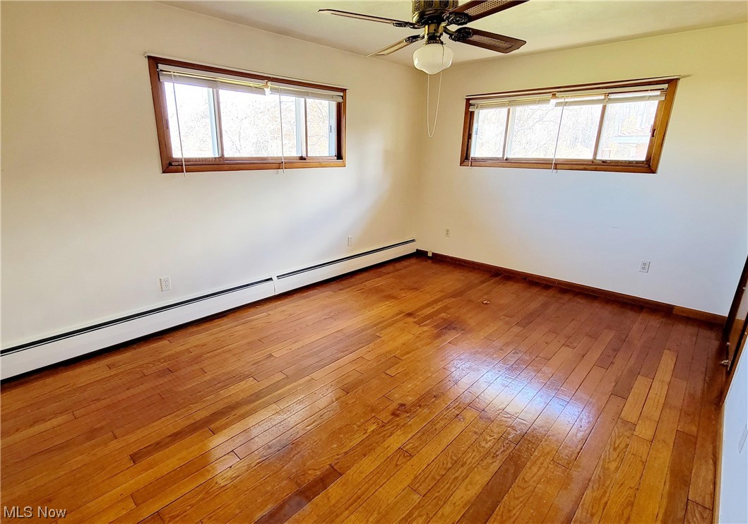 405 Bryan Road Milan, OH 44846 - Photo 14 of 35 Bedroom with plenty of natural light, ceiling fan, and wood flooring