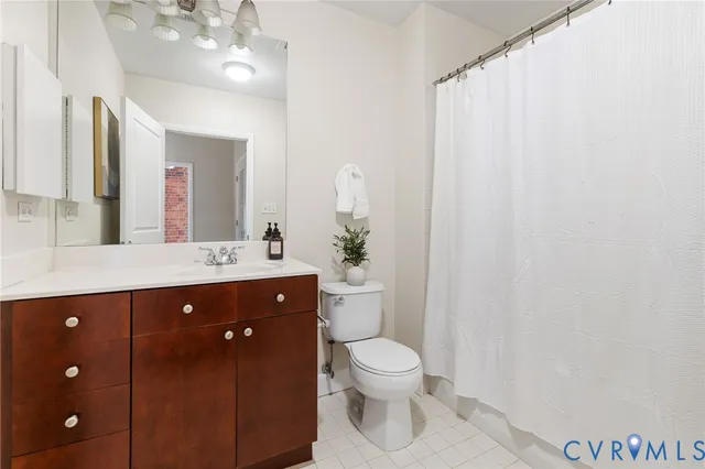 a bathroom with a sink vanity mirror and toilet