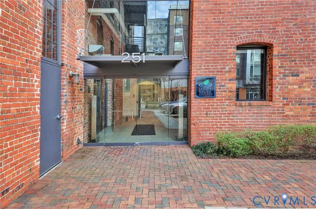 a view of a brick house with many windows