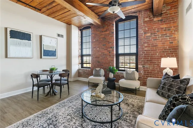 a living room with furniture and a wooden floor