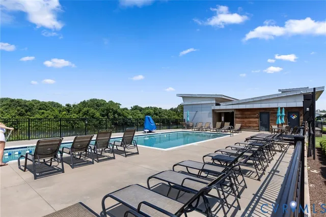 a view of a patio with table and chairs with wooden floor and fence