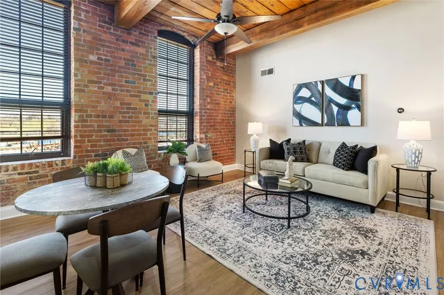 a living room with furniture and wooden floor