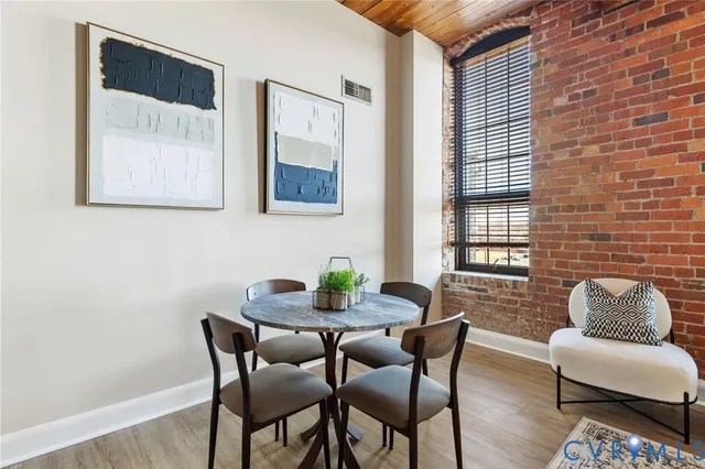 a dining room with furniture and wooden floor