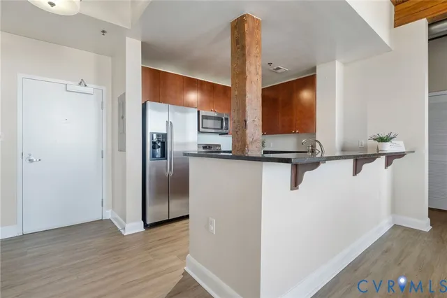 a view of a kitchen with a refrigerator and a sink