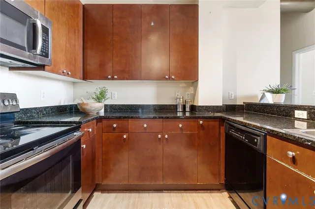 a kitchen with wooden cabinets and a stove top oven