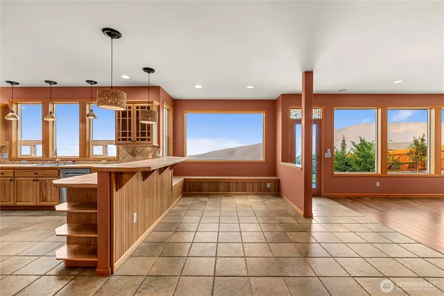 a kitchen with stainless steel appliances granite countertop a kitchen island a stove a sink a refrigerator and cabinets