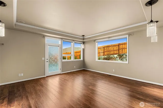 a view of a livingroom with wooden floor and a window