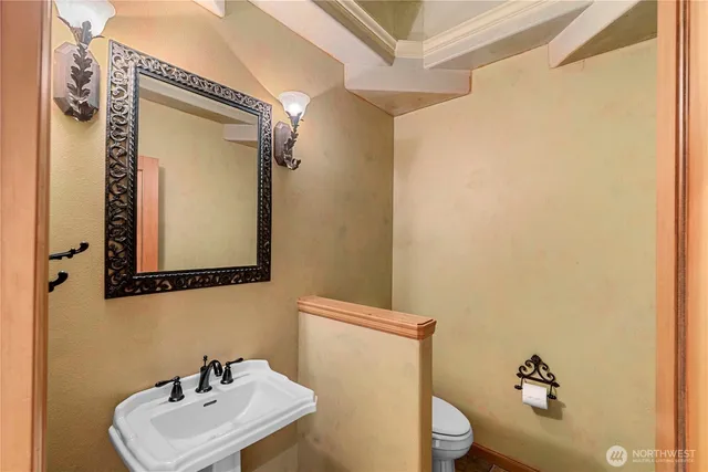 a view of an empty room with wooden floor and windows