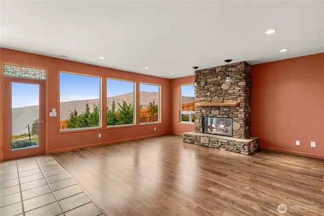 a view of room with floor to ceiling window and wooden floor