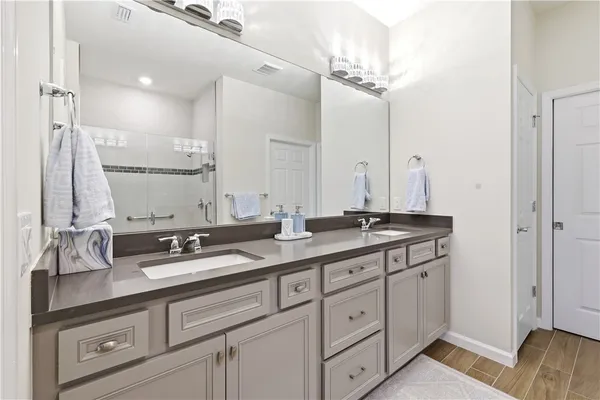 a bathroom with double sink and a mirror