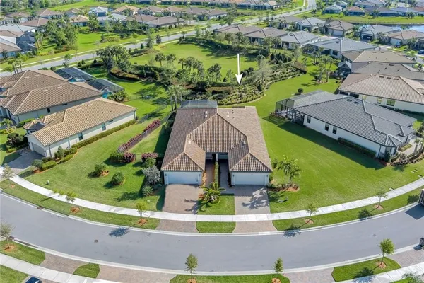 an aerial view of residential houses with outdoor space and swimming pool