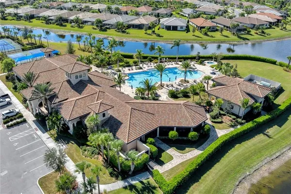 an aerial view of residential houses with outdoor space and parking