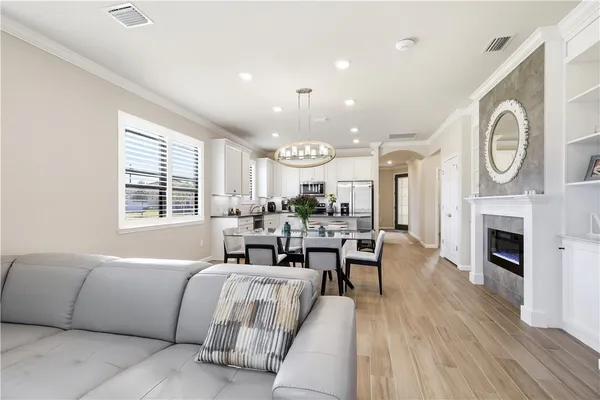 a living room with furniture a fireplace and wooden floor