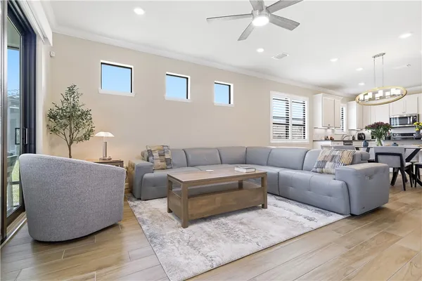 a living room with furniture and a chandelier