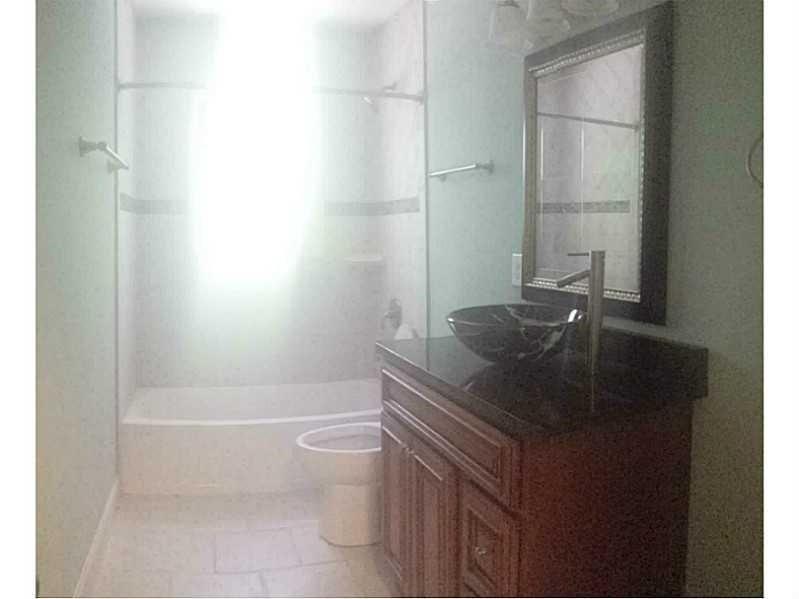 2076 Panola Road Lithonia, GA 30058 - Photo 8 of 16 a bathroom with a granite countertop sink a toilet and bathtub