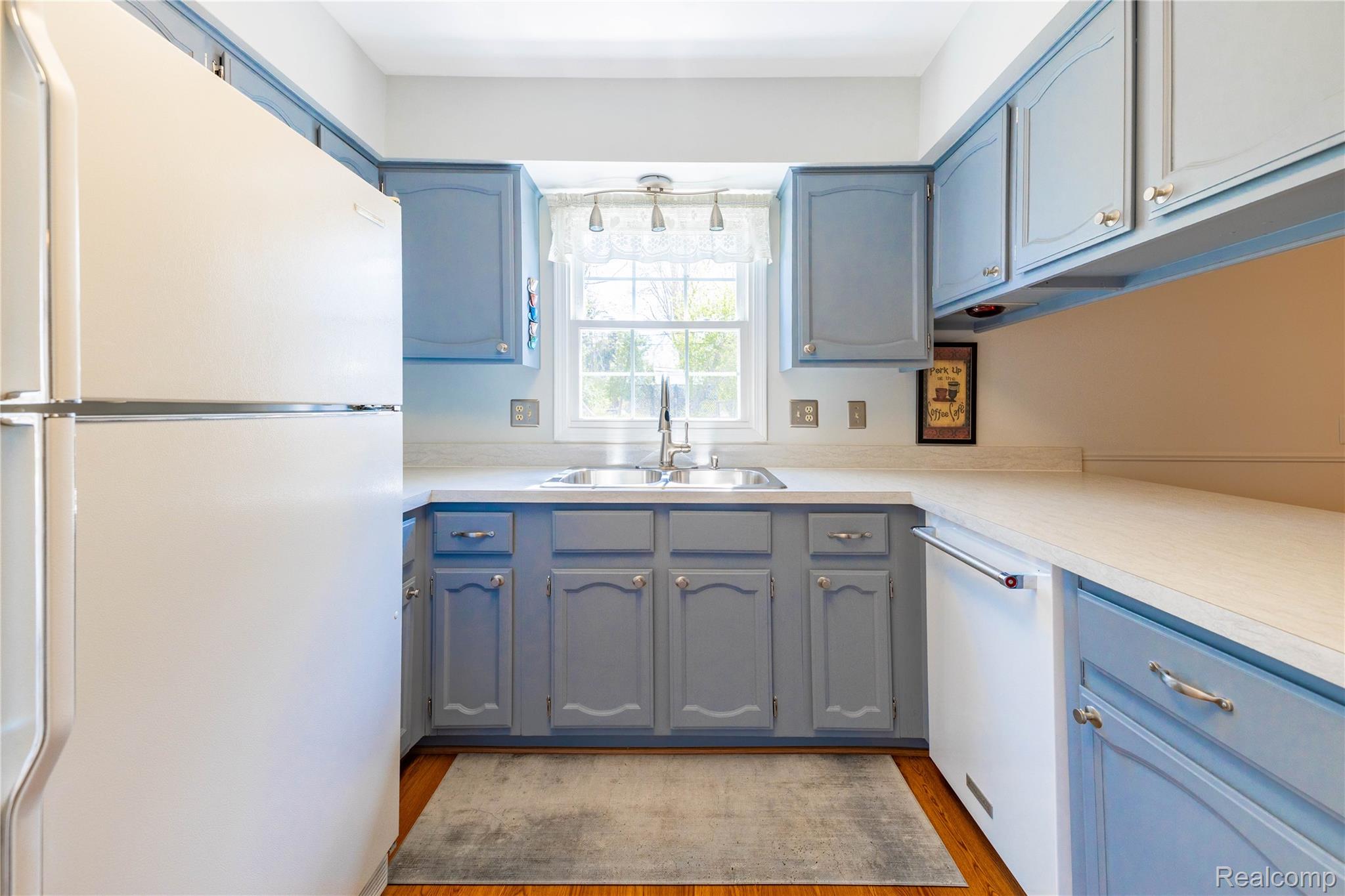 27758 Johnson Road Grosse Ile, MI 48138 - Photo 21 of 49 Kitchen with white appliances, light countertops, and light wood-type flooring