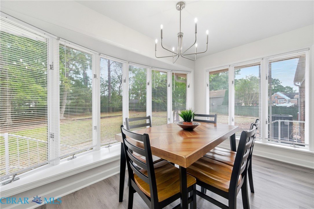 718 Dandy Loop Road Yorktown, VA 23692 - Photo 5 of 42 Sunroom / solarium featuring wood finished floors and a chandelier