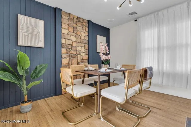 a kitchen with stainless steel appliances kitchen island granite countertop a dining table and chairs