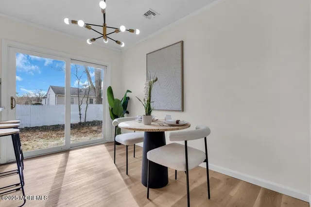 a kitchen with a sink a stove a refrigerator and white cabinets