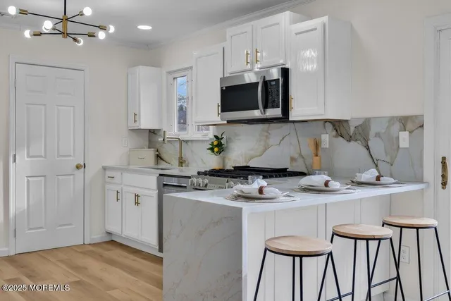 a kitchen with cabinets stainless steel appliances and a counter space