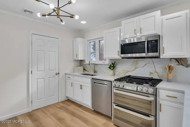 a kitchen with sink a window and cabinets