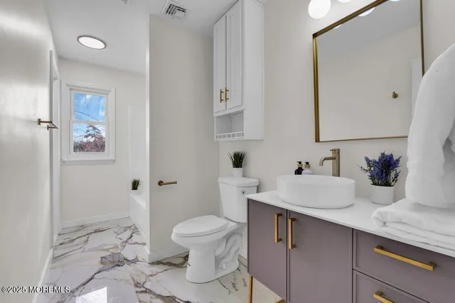 a bedroom with two beds and a painting on the wall